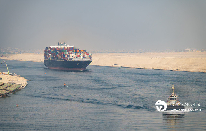 The Suez Canal is a shipping canal in Egypt. Huge Cargo ship drives through Suez Canal.