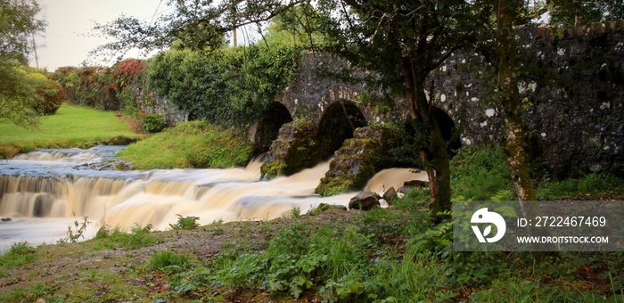 old stone bridge with waterfall