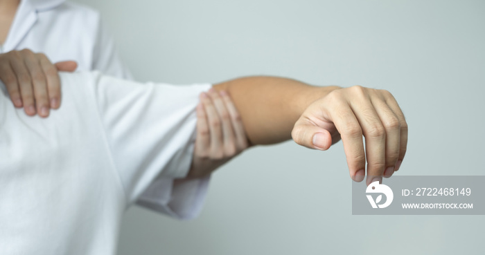 Female physiotherapists provide physical assistance to male patients with shoulder injuries massage their shoulders for muscle recovery in the rehabilitation center. Physiotherapy concepts