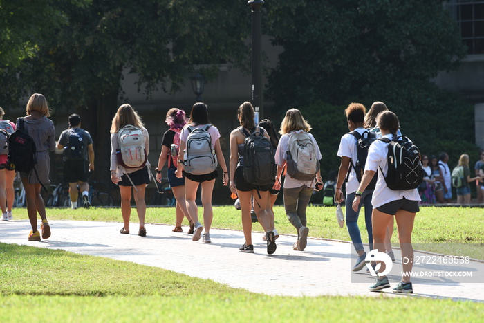 A group of female students walk across the campus of UNC Chapel Hill