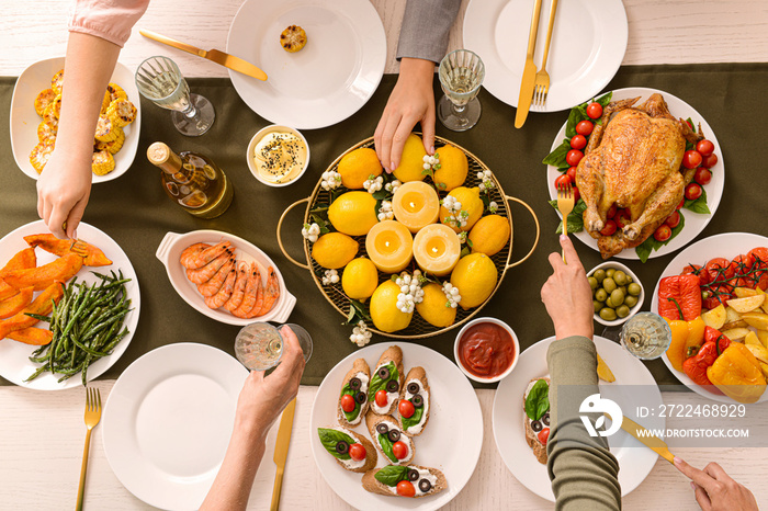 Friends having dinner at table, top view