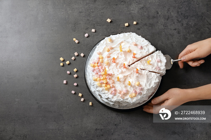 Woman and delicious birthday cake with candles on table