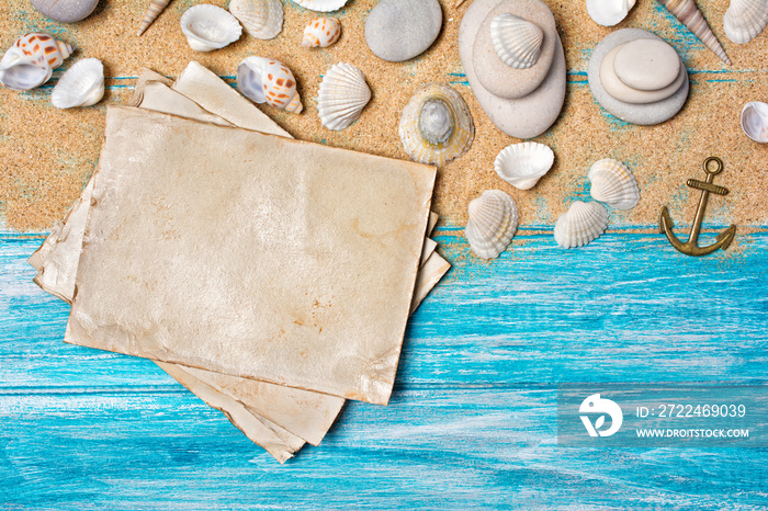 Concept of summer memories with mockup of vintage photo card and seashells on sand