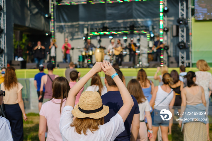 Couple is watching concert at open air music festival