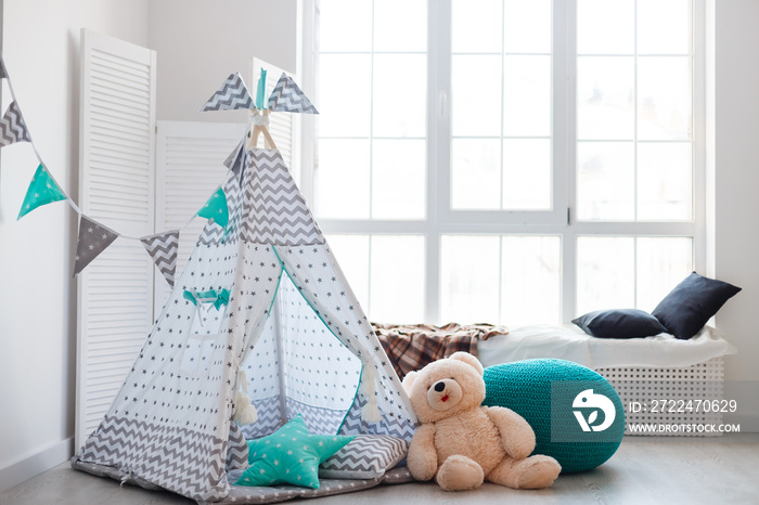 Interior room for a child. Tent for game. Wigwam with a garland of cotton balls. White and grey