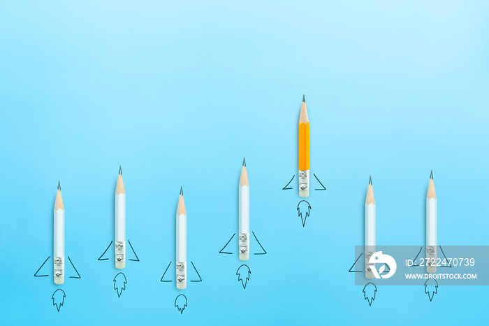 Leadership ideas and creativity concept with pencils in the form of a rocket on blue background. copy space