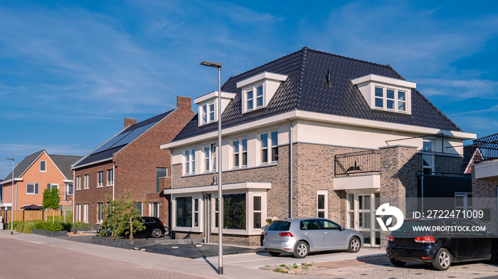 Dutch Suburban area with modern family houses, newly build modern family homes in the Netherlands, dutch family houses, and apartment houses. In the Netherlands, newly build streets with modern house