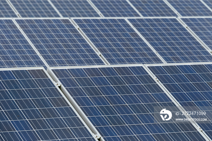 Solar panels close up on a cloudy day in Normandy, France. Solar energy, modern electric power production technology, renewable energy concept. Environmentally friendly electricity production