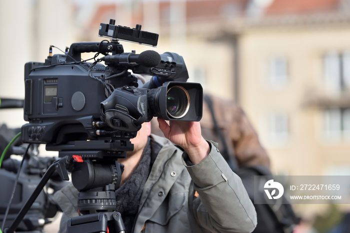 TV camera man filming a political event