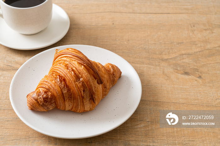 fresh croissant on white plate