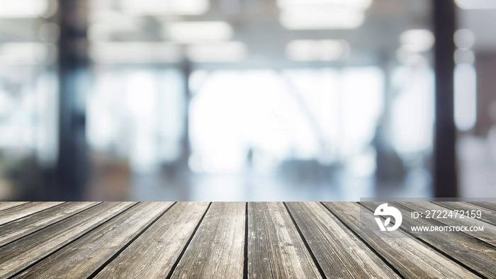 Wood table top and blurred bokeh office interior space background - can used for display or montage your products.