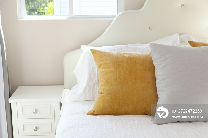 Comfortable white and yellow pillow on bed