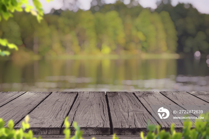 Old wood deck with blur background of lake and forest in early Autumn , for display or montage your products.