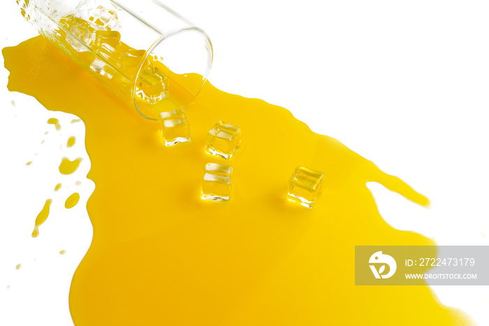 spilled glass of orange juice with ice cubes on a white background. Flat lay, top view