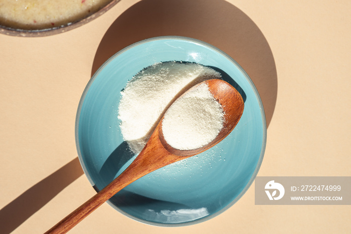 Collagen Powder and Healthy Smoothie from Banana, Pineapple and gluten free oats in the Coconut Shell Bowl, strong shadows. Healthy summer breakfast, top view