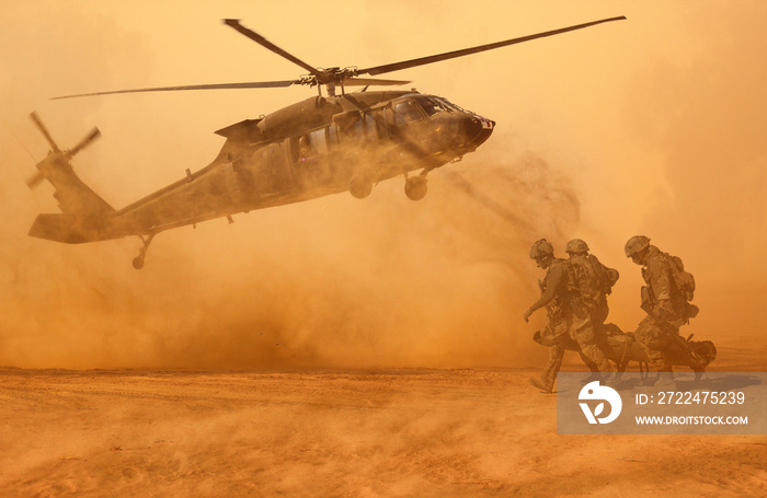 Army Soldiers carrying patient to the aircraft in the battle field