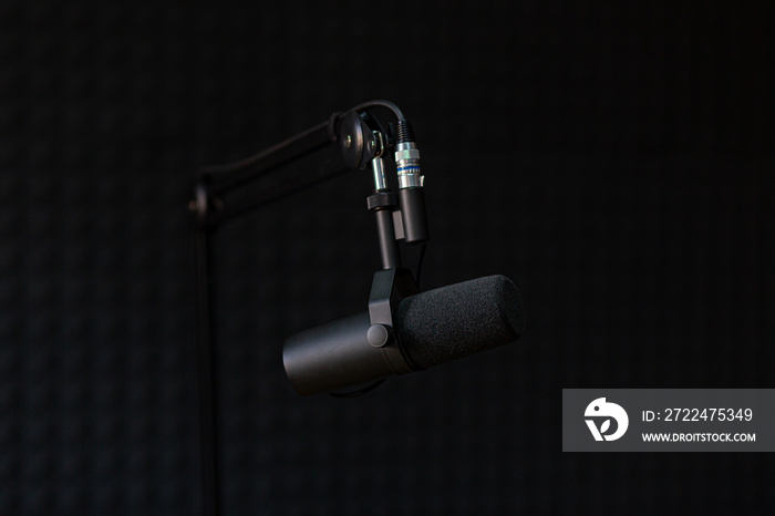 Microphone of recording studio and podcasts, on black background