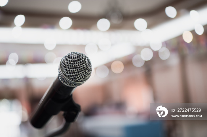 Front Microphone on abstract conference hall prepare for speaker on stage in seminar room, Business meeting and education in teaching classroom or Event light convention hall Background.