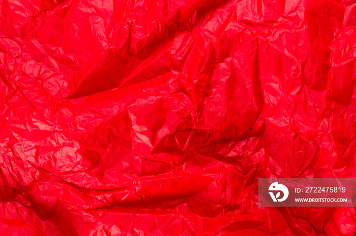 Bright red wrapping paper crumpled paper texture. Creased sheet background. Textured effect.