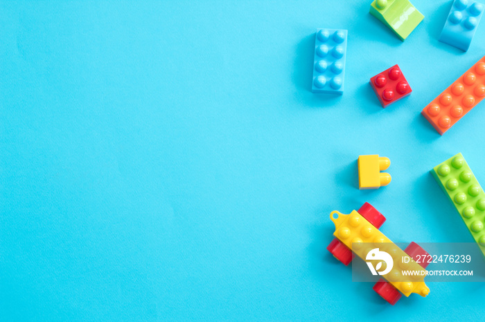 Plastic toy blocks on blue background