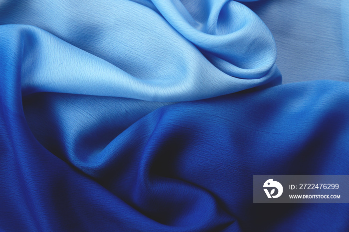 Abstract classic blue background draped silk fabric.