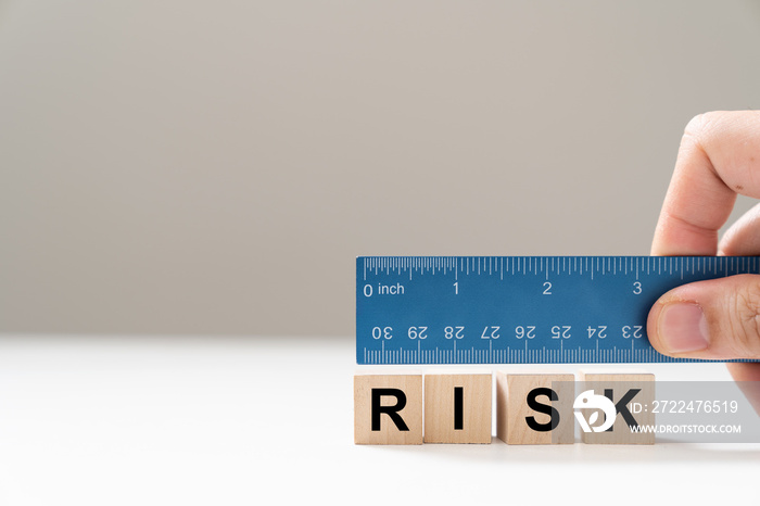 Measure the word risk with blue color ruler for risk assessment concept