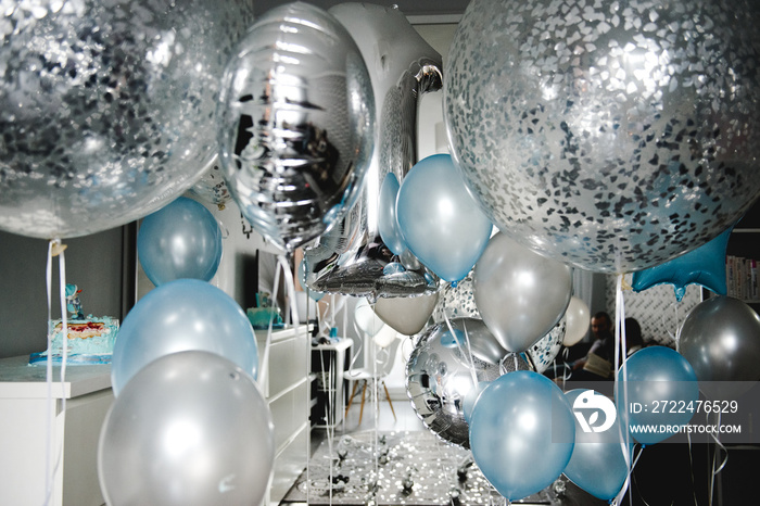 Birthday party in blue and silver. Many different balloons