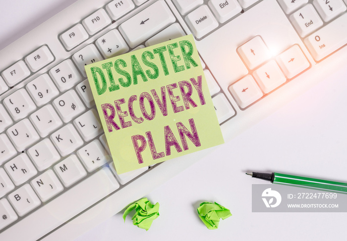 Writing note showing Disaster Recovery Plan. Business concept for having backup measures against dangerous situation Green note paper with pencil on white background and pc keyboard