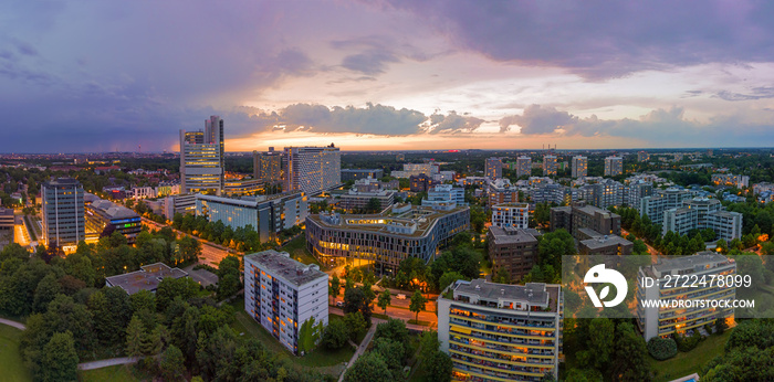 Munich from above, a panoramic droneshot in the colorful evening with office bulidings in a working discrict.