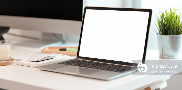 Laptop on white wooden table in modern office room