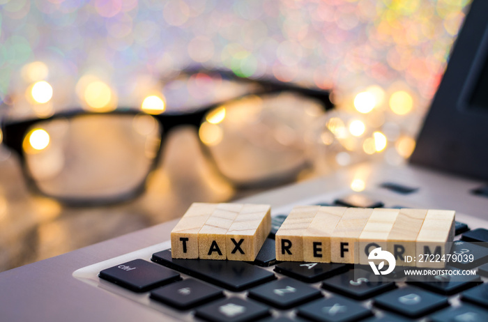 Tax Reform still life business finance concept with laptop, stock chart, shallow DOF