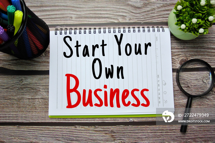 Selective focus is magnify glasses, compass, colorful pen and notebook written with START YOUR OWN BUSINESS. Business, financial, self-employees, online business concept during covid-19.