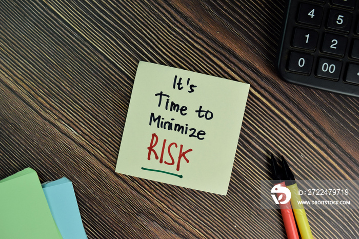 It’s Time to Minimize Risk write on sticky notes isolated on Wooden Table.