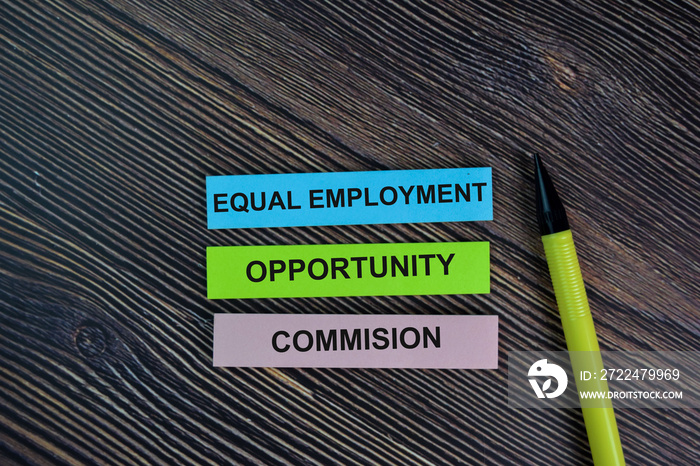 Equal Employment Opportunity Commision write on sticky notes isolated on Wooden Table.