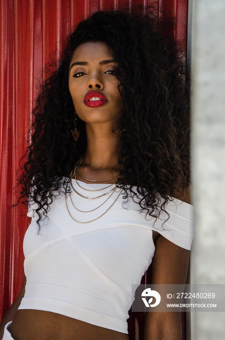 Black woman with red lips looking at camera