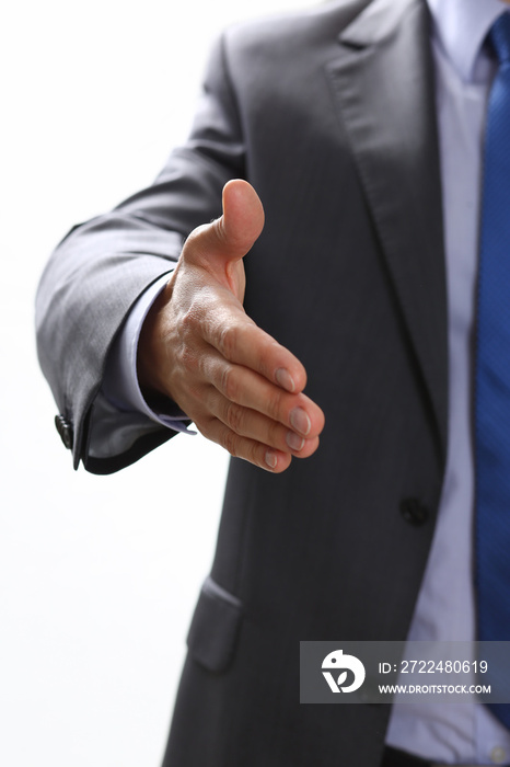 Man in suit and tie give hand as hello in office closeup. Friend welcome, mediation offer, positive introduction, thanks gesture, summit participate approval, motivation, male arm, strike bargain