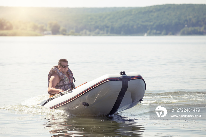 Man driving white motor boat