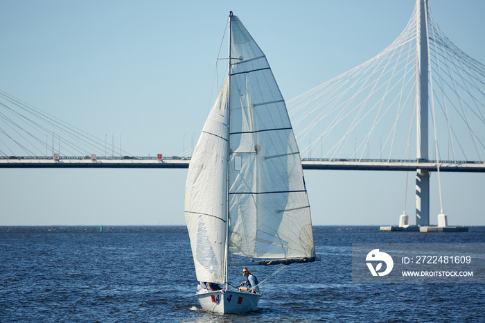 Yachtsmen participating in sport competition on sailing during windy weather