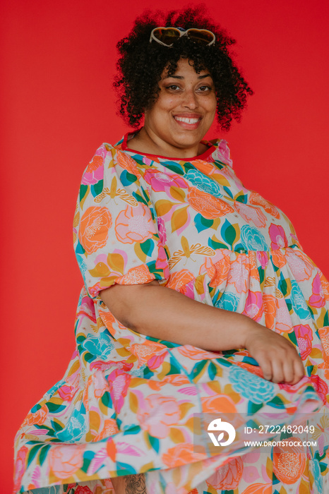 portrait of a plus size black person twirling in dress