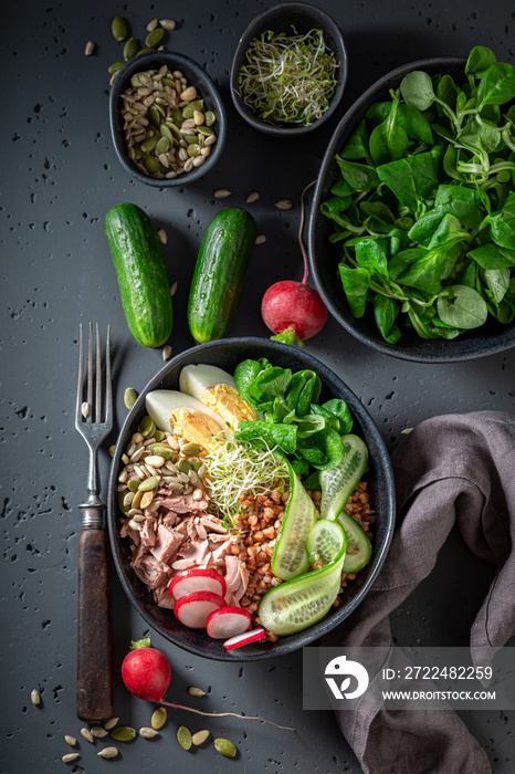 Diet Nicoise salad with cucumber, tuna and eggs.