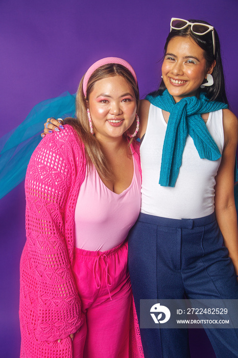 Asian female duo colour blocked fashion studio portrait