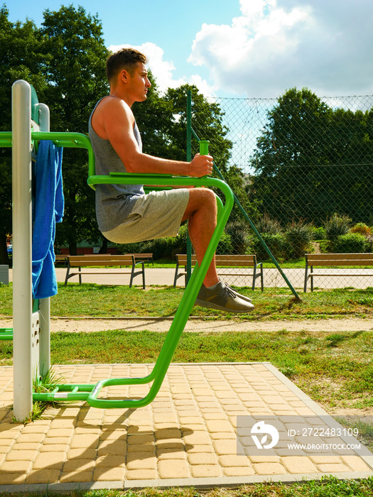 Man doing legs exercises in outdoor gym