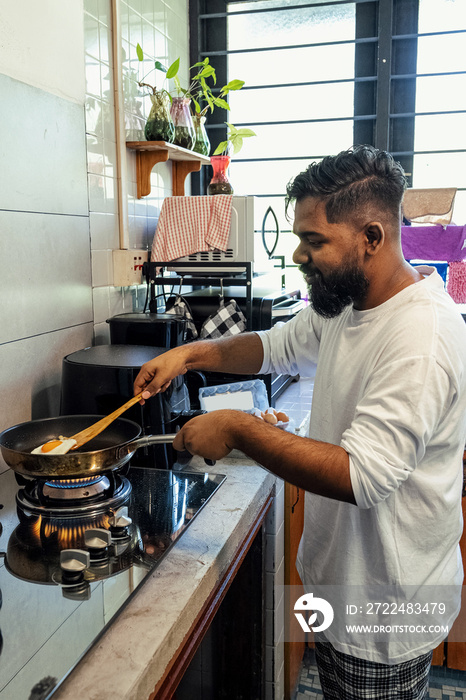 Couple making breakfast together at home in the morning