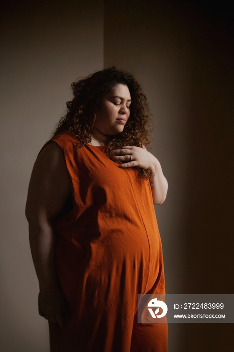 Plus-sized Sri Lankan woman with vitiligo meditating in her bedroom