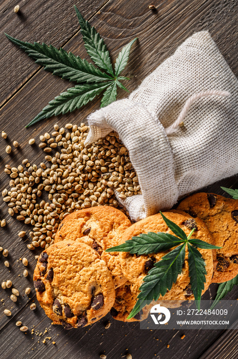 Cookies with cannabis and buds of marijuana on the table. A can of cannabis buds CBD Concept of cooking with cannabis herb. - Medical Legal Marijuana