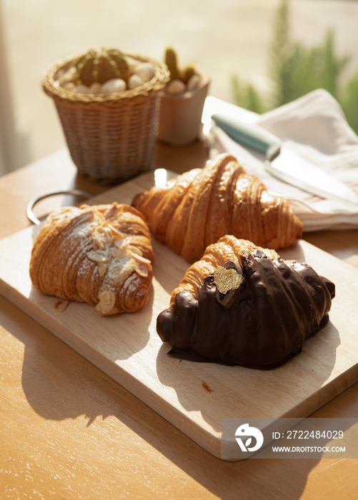 Homemade Half Chocolate Croissants,nuts flakes crumbs croissants on the table