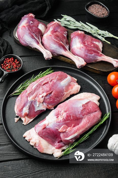 Free range Duck meat, with herbs and ingredients, on black wooden table background