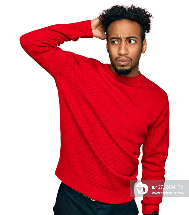 Young african american man with beard wearing casual winter sweater confuse and wondering about question. uncertain with doubt, thinking with hand on head. pensive concept.