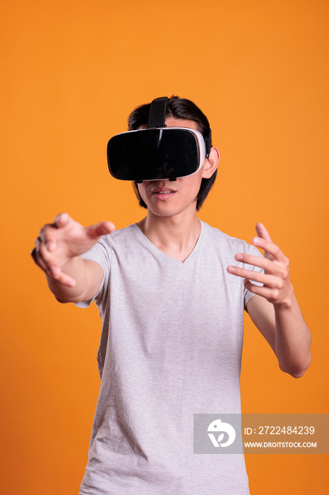 Man wearing vr headset playing virtual reality games in cyber space, enjoying simulation experience, exploring metaverse. Cyberspace entertainment, leisure activity, modern technology