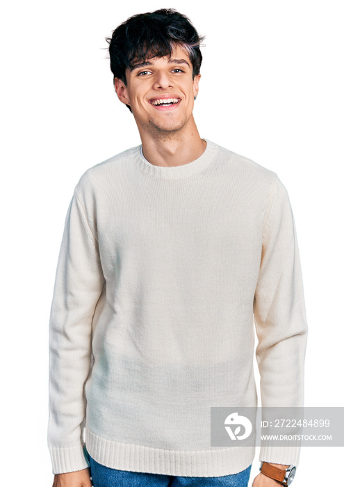 Handsome hipster young man wearing casual winter sweater with a happy and cool smile on face. lucky person.